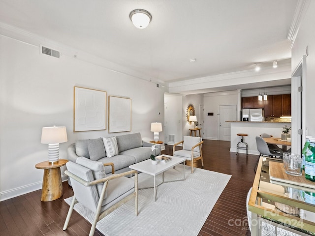 living room with dark hardwood / wood-style floors and ornamental molding