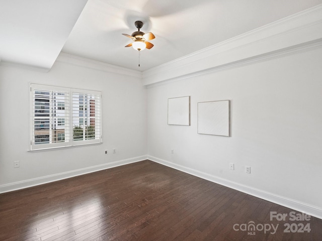 spare room featuring crown molding, ceiling fan, and dark wood-type flooring