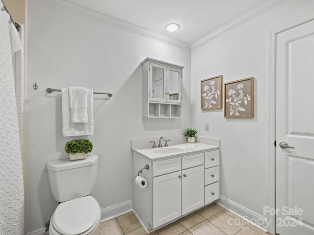 bathroom featuring tile patterned floors, toilet, vanity, and ornamental molding