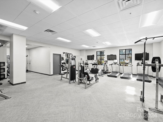 gym with a drop ceiling and light colored carpet