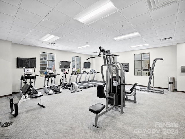 workout area with a drop ceiling and carpet floors