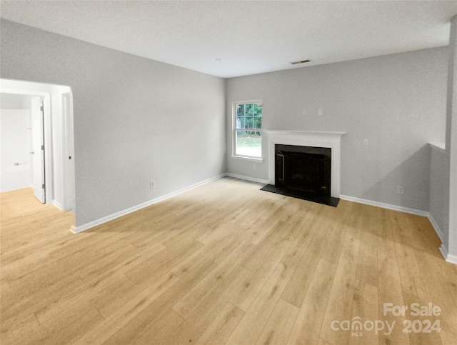 unfurnished living room with light hardwood / wood-style flooring