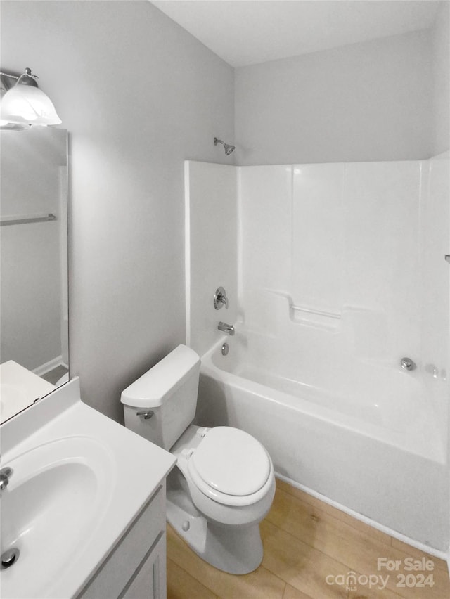 full bathroom with vanity, hardwood / wood-style flooring, toilet, and shower / bathtub combination