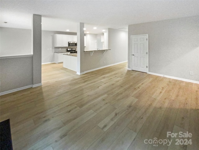 unfurnished living room featuring light wood-type flooring