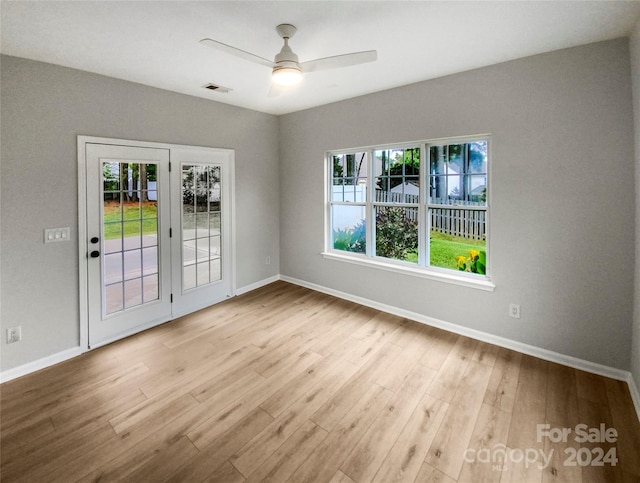 unfurnished room with light hardwood / wood-style floors and ceiling fan