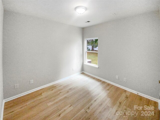 unfurnished room featuring hardwood / wood-style floors