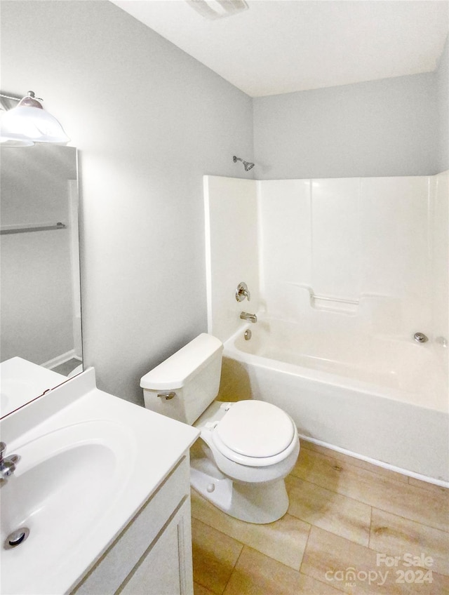 full bathroom with vanity, toilet, and  shower combination