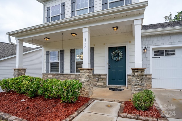 entrance to property with a porch and a garage