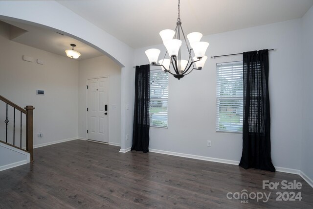 entrance foyer featuring dark hardwood / wood-style floors and a notable chandelier