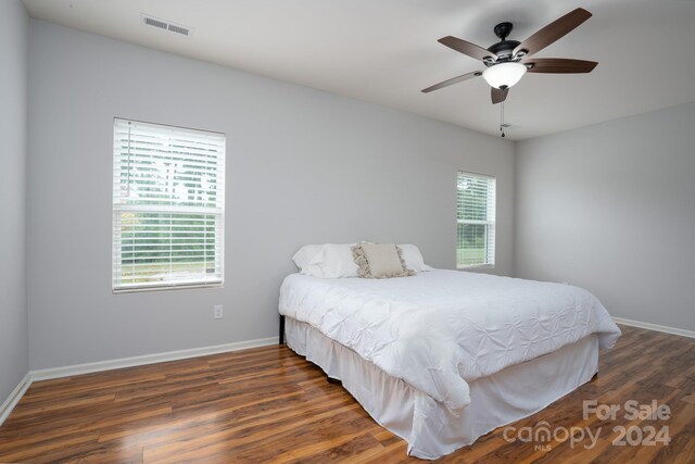 bedroom with ceiling fan and dark hardwood / wood-style flooring