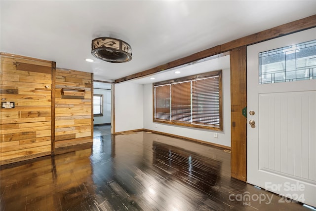 entryway featuring wood walls and dark hardwood / wood-style flooring