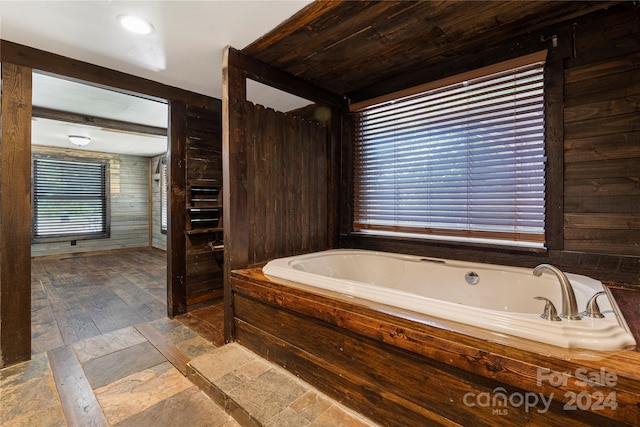 bathroom with wooden walls and a tub