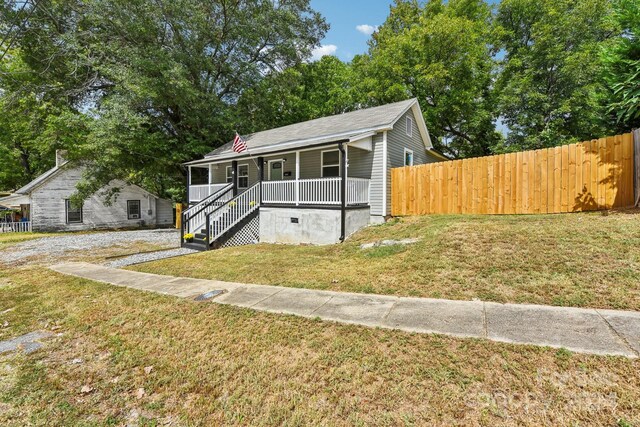 bungalow featuring a front yard and a porch