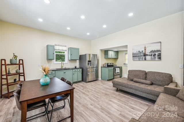 living room featuring sink and light hardwood / wood-style floors