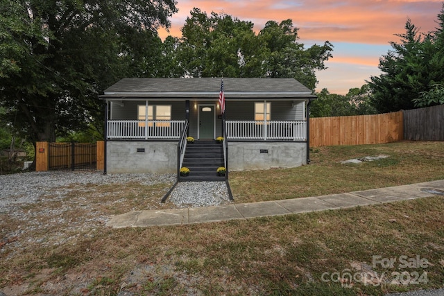 bungalow-style house featuring a yard and a porch