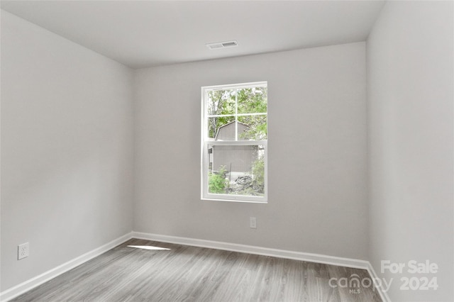 empty room with wood-type flooring