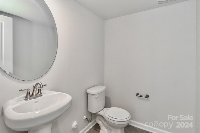 bathroom featuring hardwood / wood-style flooring, sink, and toilet