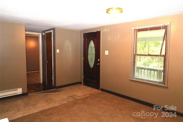 entryway featuring baseboard heating and carpet floors