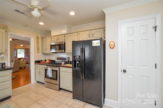 kitchen with crown molding, light tile patterned floors, ceiling fan, and stainless steel appliances