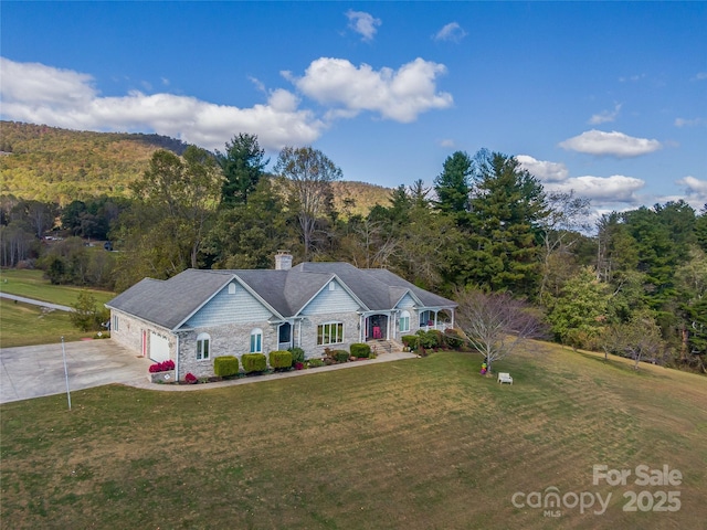 ranch-style home with a garage and a front lawn