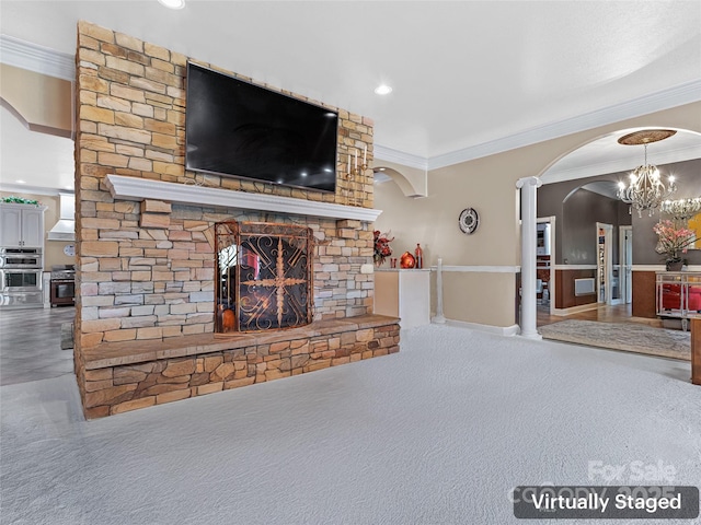 unfurnished living room featuring ornamental molding, a stone fireplace, and carpet flooring