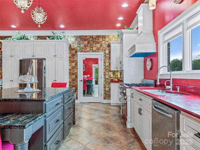 kitchen featuring premium range hood, white cabinets, pendant lighting, and stainless steel appliances