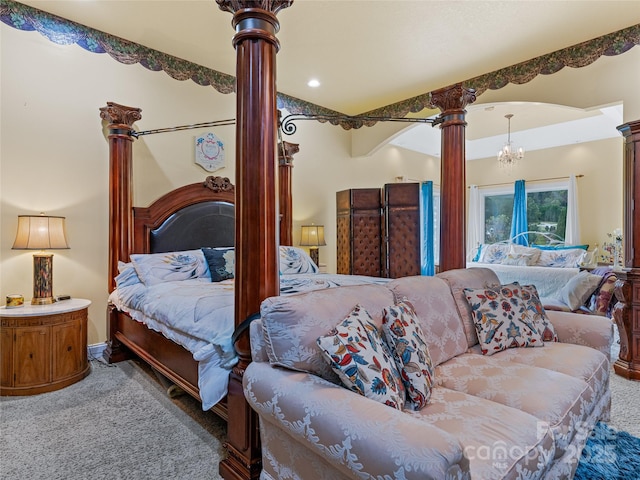 carpeted bedroom featuring decorative columns