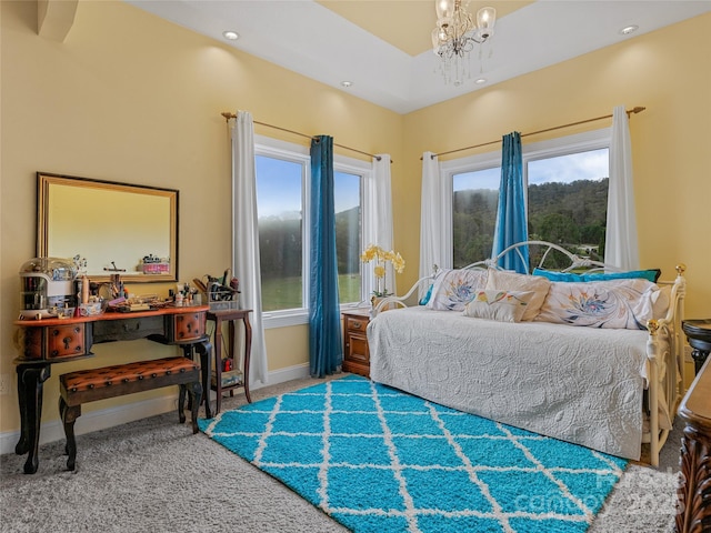 bedroom with a notable chandelier and carpet flooring