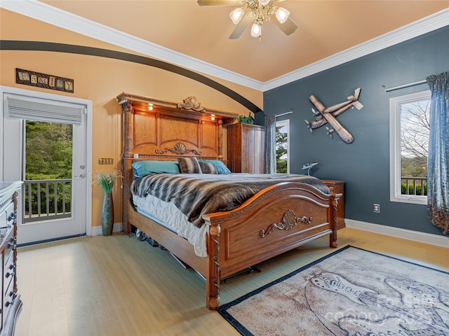 bedroom with ceiling fan, access to exterior, multiple windows, and ornamental molding