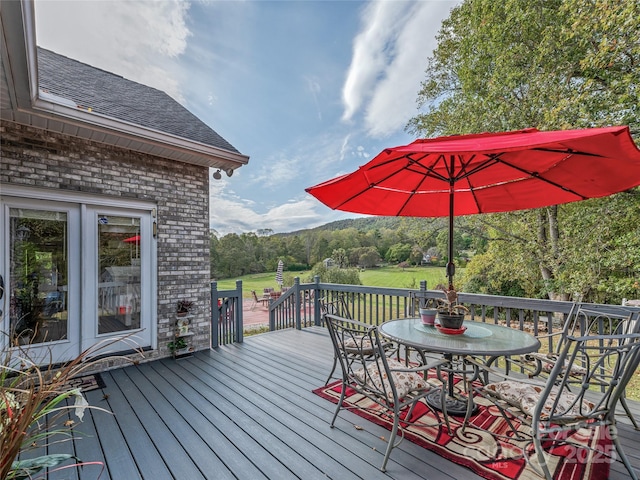 deck with outdoor dining area