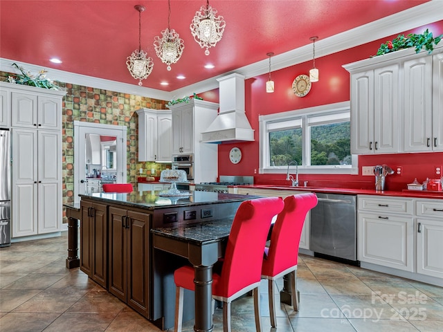 kitchen with premium range hood, white cabinetry, a kitchen breakfast bar, appliances with stainless steel finishes, and a center island