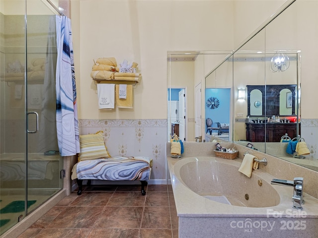 full bathroom featuring a jetted tub, a stall shower, and a wainscoted wall