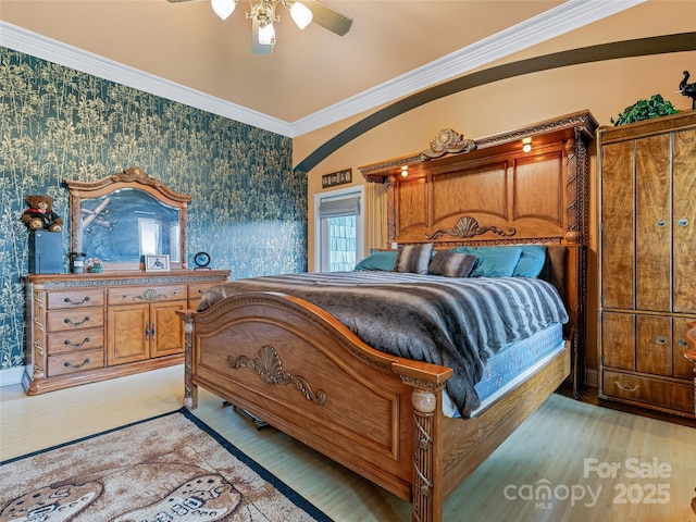 bedroom with ornamental molding, light wood finished floors, and wallpapered walls