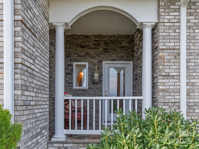 entrance to property featuring brick siding