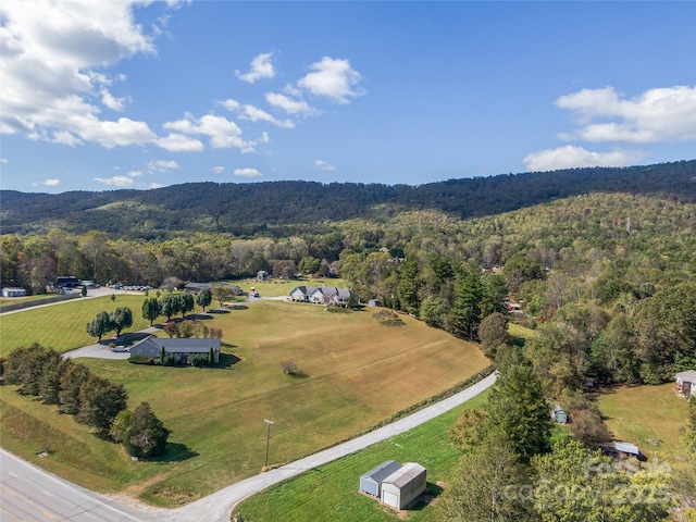 birds eye view of property featuring a rural view and a wooded view