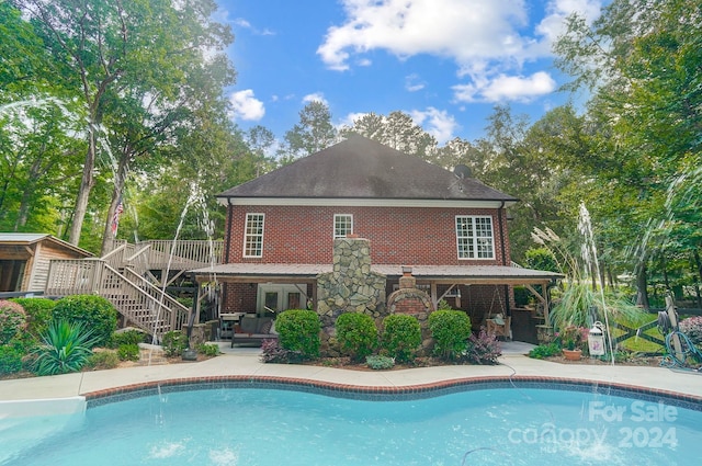 view of swimming pool with a deck and a patio area