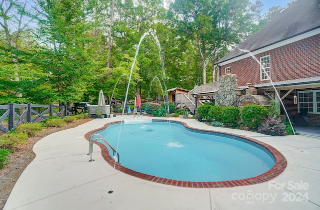 view of pool with a deck and a patio area