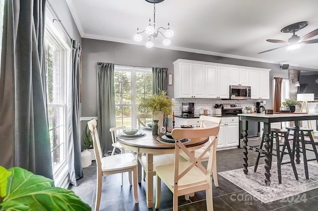 tiled dining area with ceiling fan with notable chandelier and ornamental molding