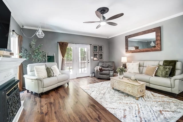 living room featuring ceiling fan, ornamental molding, and dark hardwood / wood-style flooring