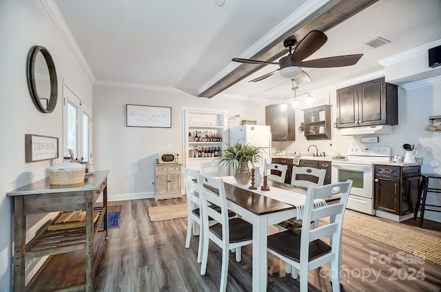 dining room featuring wood-type flooring, beam ceiling, ceiling fan, ornamental molding, and sink