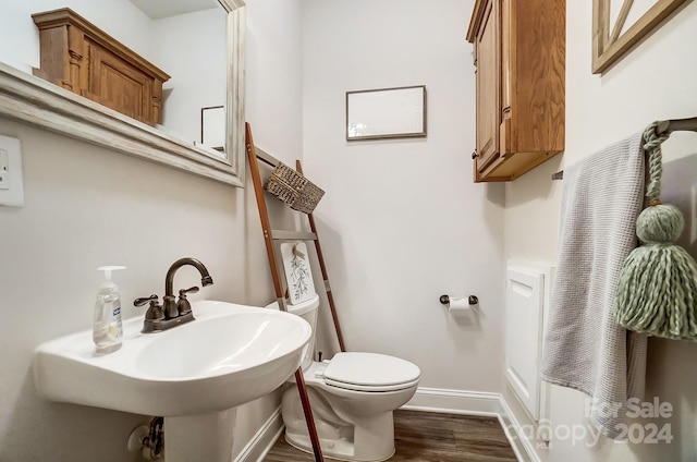 bathroom featuring sink, hardwood / wood-style flooring, and toilet