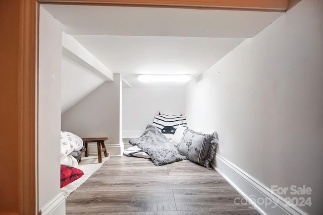 bedroom featuring vaulted ceiling and hardwood / wood-style floors