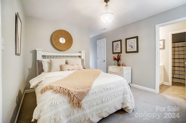 carpeted bedroom with connected bathroom