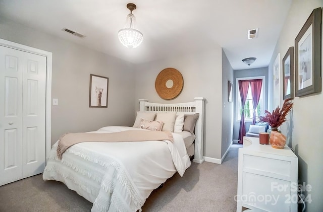 bedroom with light colored carpet and a closet