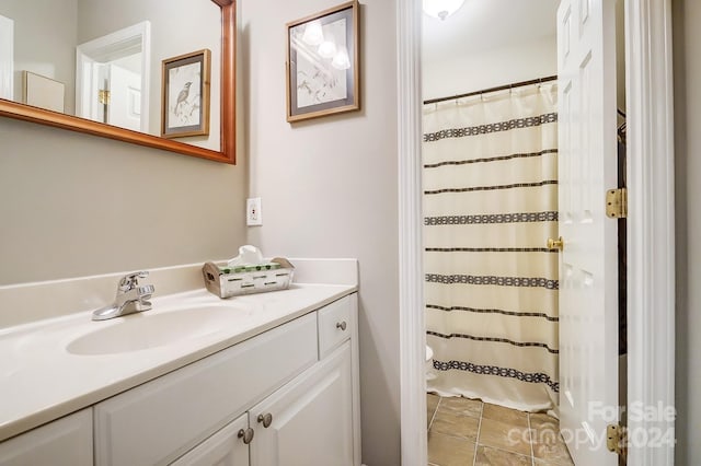 bathroom featuring vanity and curtained shower