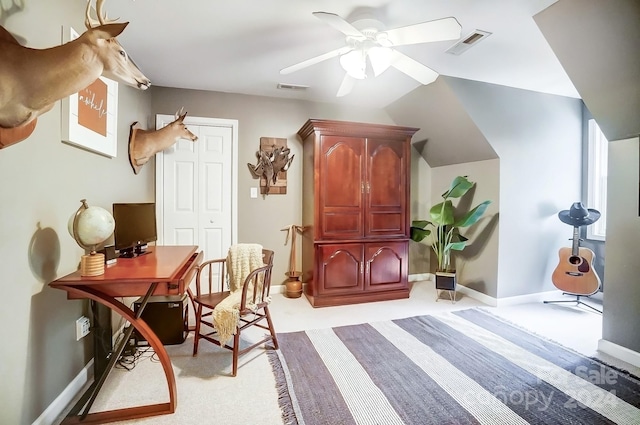 living area with ceiling fan, light carpet, and vaulted ceiling