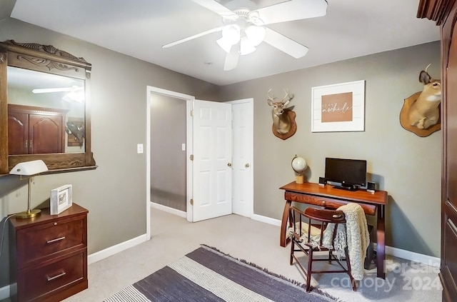 office space with light carpet and ceiling fan