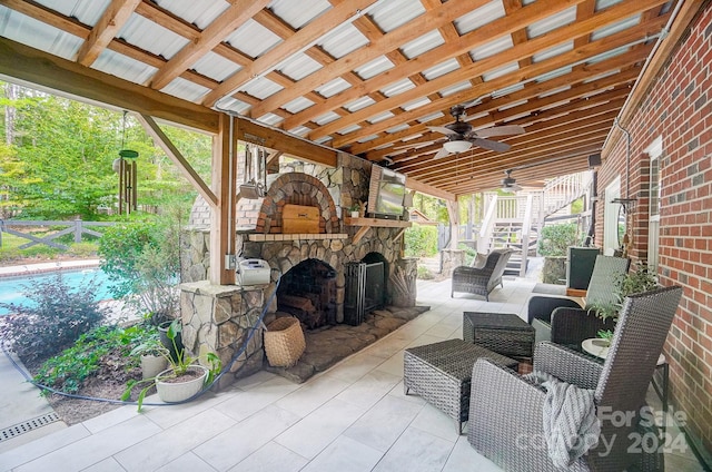 view of patio with an outdoor living space with a fireplace and ceiling fan