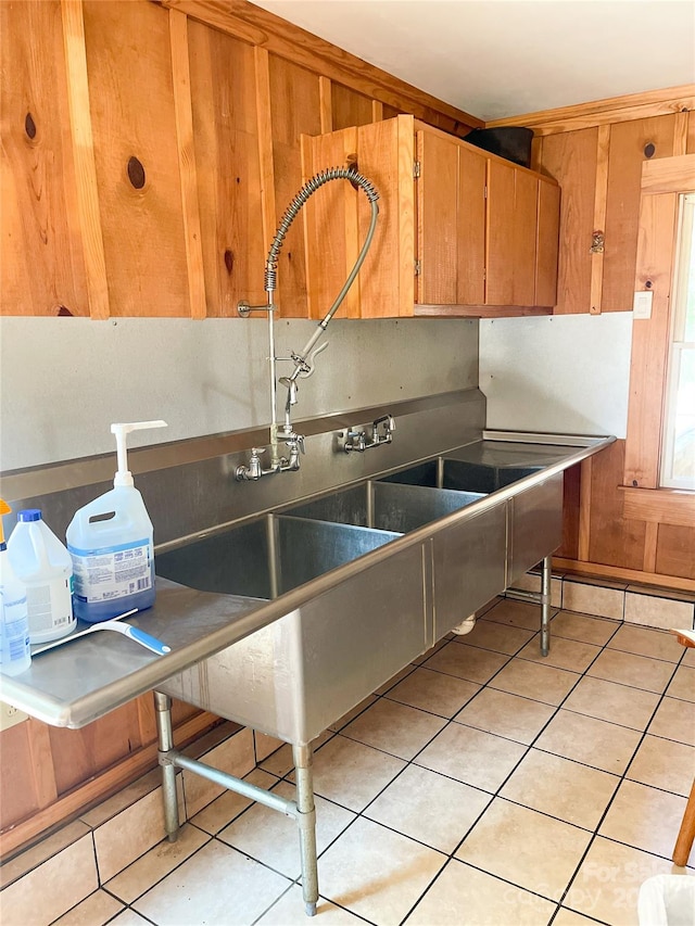 kitchen featuring light tile patterned floors and sink