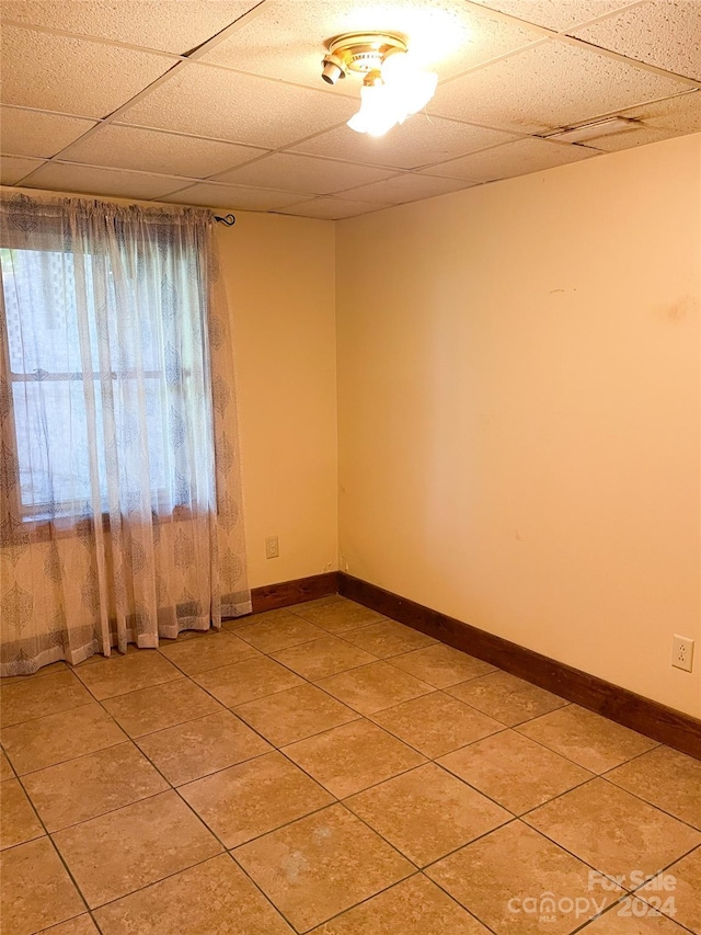 1610 Sierra Rd, York, SC 29745 - spare room featuring a paneled ceiling, baseboards, and light tile patterned floors